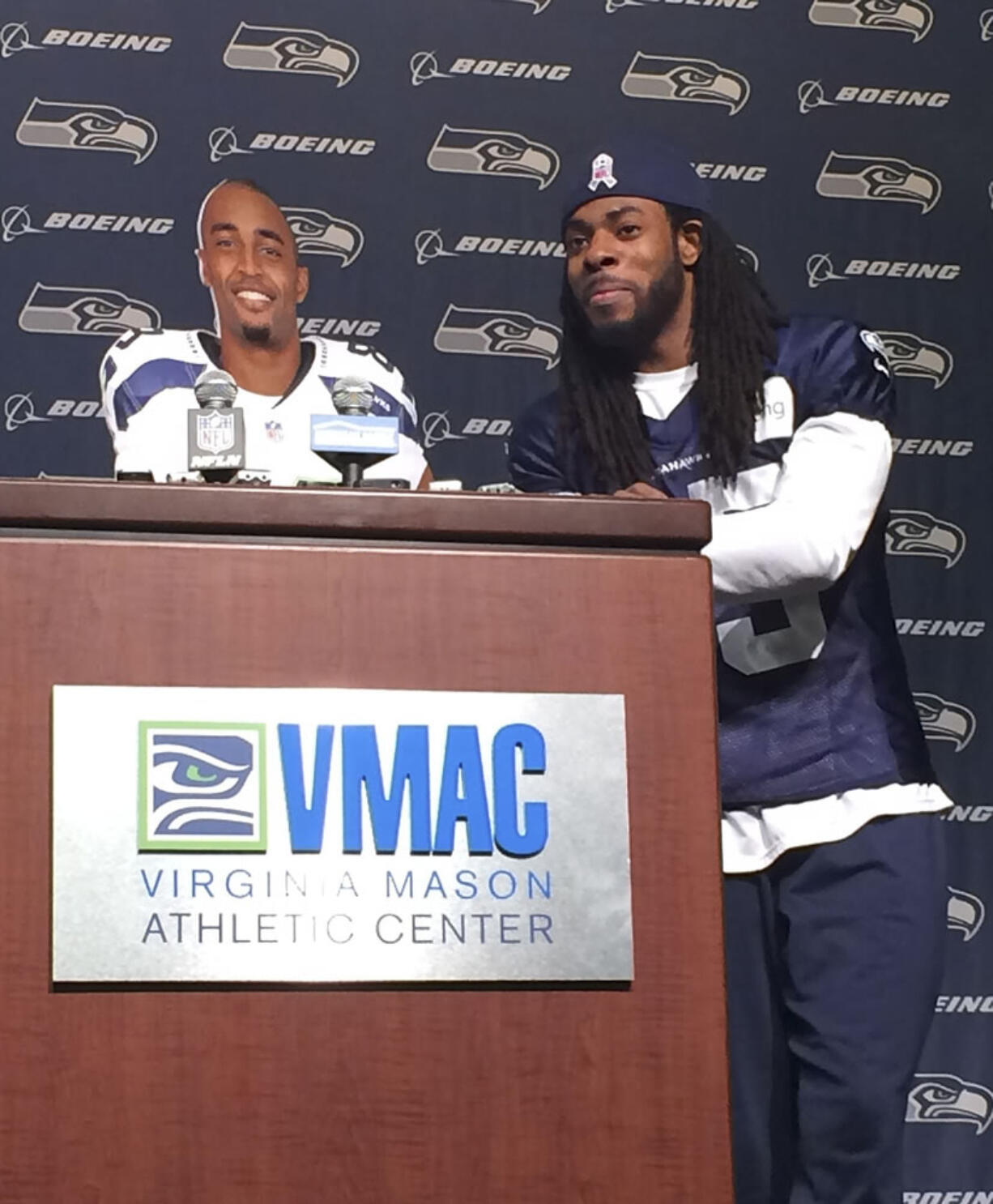 Seattle Seahawks cornerback Richard Sherman, right, stands beside a cardboard cutout of wide receiver Doug Baldwin Tuesday in Renton.