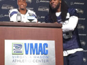 Seattle Seahawks cornerback Richard Sherman, right, stands beside a cardboard cutout of wide receiver Doug Baldwin Tuesday in Renton.