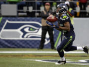 FILE - In this Aug. 14, 2015, file photo, Seattle Seahawks wide receiver Tyler Lockett begins his 103-yard kickoff return for a touchdown against the Denver Broncos in the first half of a preseason NFL football game in Seattle. All the concerns that emerged from Seattle's preseason opener were muted thanks to the standout performances from the Seahawks top two draft picks, defensive end Frank Clark and wide receiver Tyler Lockett.