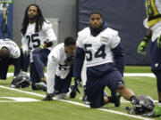 Seattle Seahawks cornerback Richard Sherman (25) and linebacker Bobby Wagner (54) stretch with other defensive players during practice, Friday, Jan. 23, 2015, in Renton, Wash. The Seahawks face the New England Patriots in Super Bowl XLIX on Sunday, Feb. 1, 2015, in Glendale, Ariz. (AP Photo/Ted S.