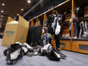 Seattle Seahawks defensive end Cliff Avril packs up football cleats and other items in front of his his space in the team locker room, Tuesday, Feb. 3, 2015, in Renton. (AP Photo/Ted S.