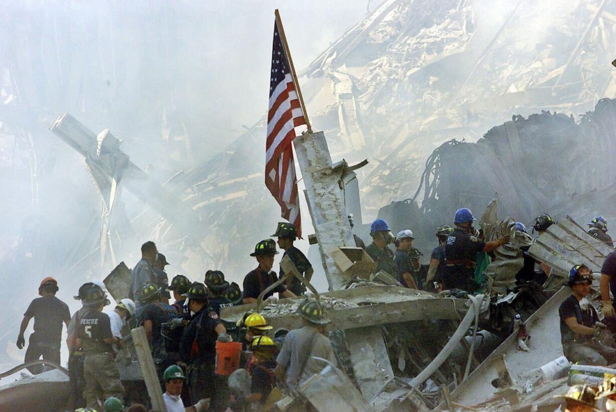 An American flag flies Sept. 13, 2001, at Ground Zero over the rubble of the collapsed World Trade Center buildings in New York. For years, a handful of current and former American officials have been urging President Barrack Obama to release secret files that they believe document links between the government of Saudi Arabia and the terrorist attacks of Sept. 11, 2001.