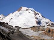 In this Aug. 7, 2015, photo Mount Baker, Wash., is visible during a clear morning. Glaciers on Mount Baker and other mountains in the North Cascades are thinning and retreating.