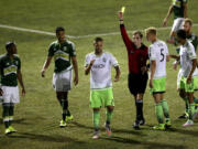 Seattle Sounders FC's forward Clint Dempsey (2) appears to rip up referee Daniel Radford's notebook after Radford issued a red card to teammate Michael Ariza while playing the Portland Timbers in a U.S. Open Cup soccer match at Starfire Stadium in Tukwila, Wash. Dempsey was issued a red card his actions.