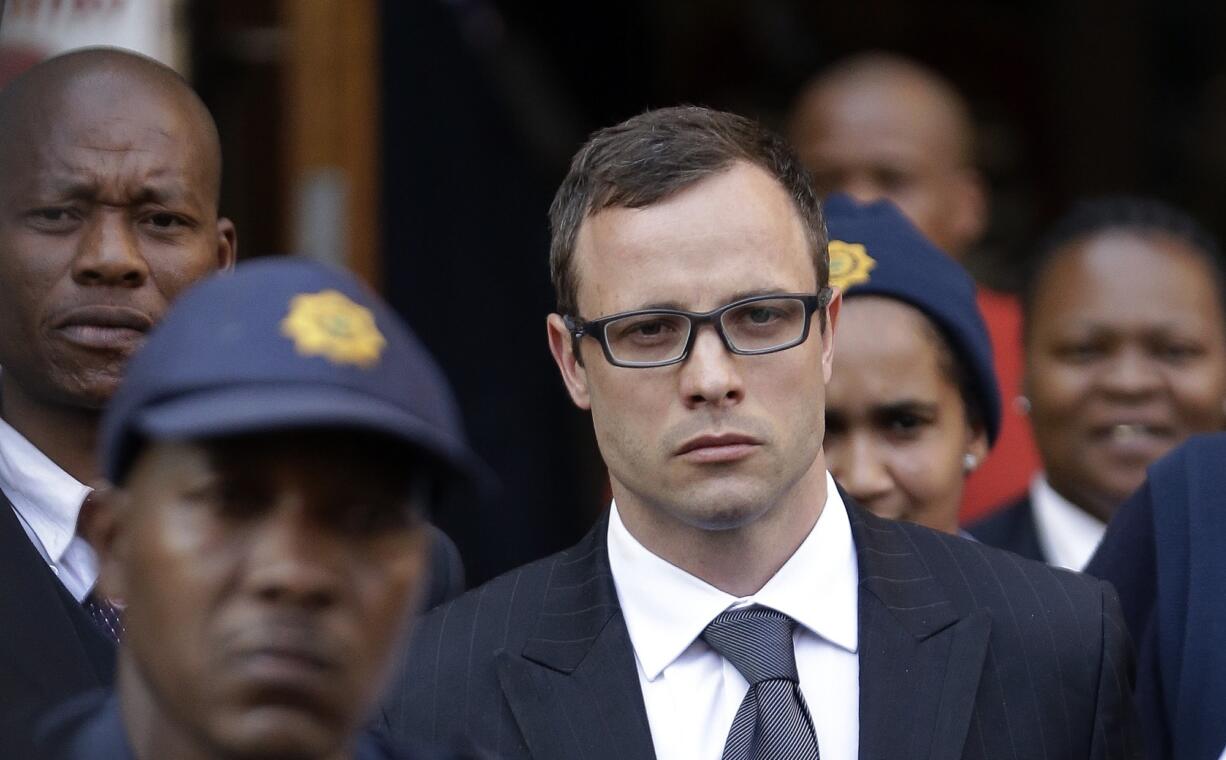 Oscar Pistorius, center, leaves the high court in Pretoria, South Africa, on Thursday.