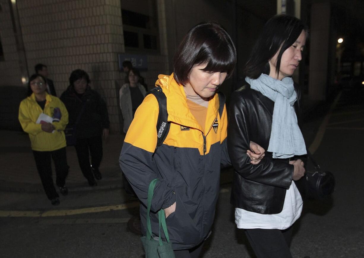 Family member of passengers aboard the sunken ferry Sewol leave after a trial of crew members of the ferry at Gwangju District Court in Gwangju, South Korea, on Monday.