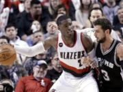 Portland Trail Blazers guard Wesley Matthews, left, works the ball in on San Antonio Spurs guard Marco Belinelli during the second half of an NBA basketball game in Portland, Ore., Wednesday, Feb. 25, 2015.  Matthews led the Trail Blazers in scoring with 31 points as Portland won 111-95.