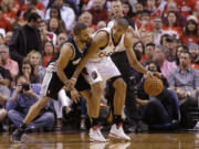 The Spurs' Tony Parker, left, guards the Blazers' Nicolas Batum, in the first quarter during the playoffs last season.