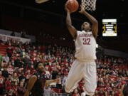 Washington State guard Que Johnson (32) drives to the basket past Stanford guard Chasson Randle (5) during the second half Saturday, January 31, 2015, in Pullman. Washington State won 89-88.