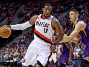 Portland Trail Blazers forward LaMarcus Aldridge, left, posts up Monday against Phoenix Suns center Alex Len, right, during the third quarter of an NBA basketball game in Portland.