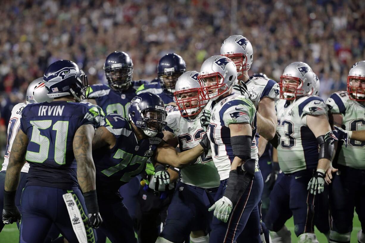 Seattle Seahawks outside linebacker Bruce Irvin (51), far left, gets into a brawl at the end of Super Bowl XLIX  against the New England Patriots on Sunday, Feb. 1, 2015, in Glendale, Ariz.