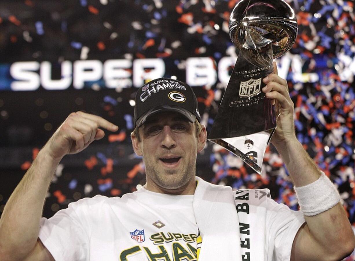 Green Bay Packers' Aaron Rodgers holds the Vince Lombardi Trophy while celebrating the Packers' 31-25 win against the Pittsburgh Steelers.