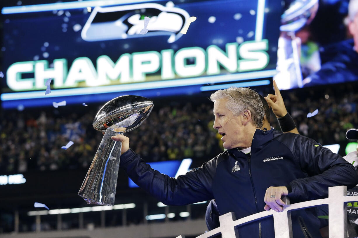 Seattle Seahawks head coach Pete Carroll holds the the Vince Lombardi Trophy after they defeated the Denver Broncos 43-8 in Super Bowl XLVIII  in East Rutherford, N.J. The Seahawks will defend their title against the New England Patriots in Super Bowl XLIX on Sunday, Feb.