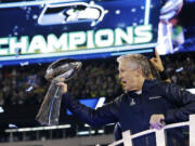 Seattle Seahawks head coach Pete Carroll holds the the Vince Lombardi Trophy after they defeated the Denver Broncos 43-8 in Super Bowl XLVIII  in East Rutherford, N.J. The Seahawks will defend their title against the New England Patriots in Super Bowl XLIX on Sunday, Feb.