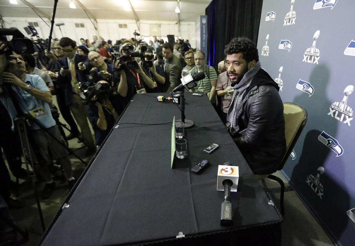 Seattle Seahawks' Russell Wilson answers a question at a news conference after arriving for Super Bowl XLIX on Sunday, Jan. 25, 2015, in Phoenix. The Seahawks play the New England Patriots on Sunday, Feb.