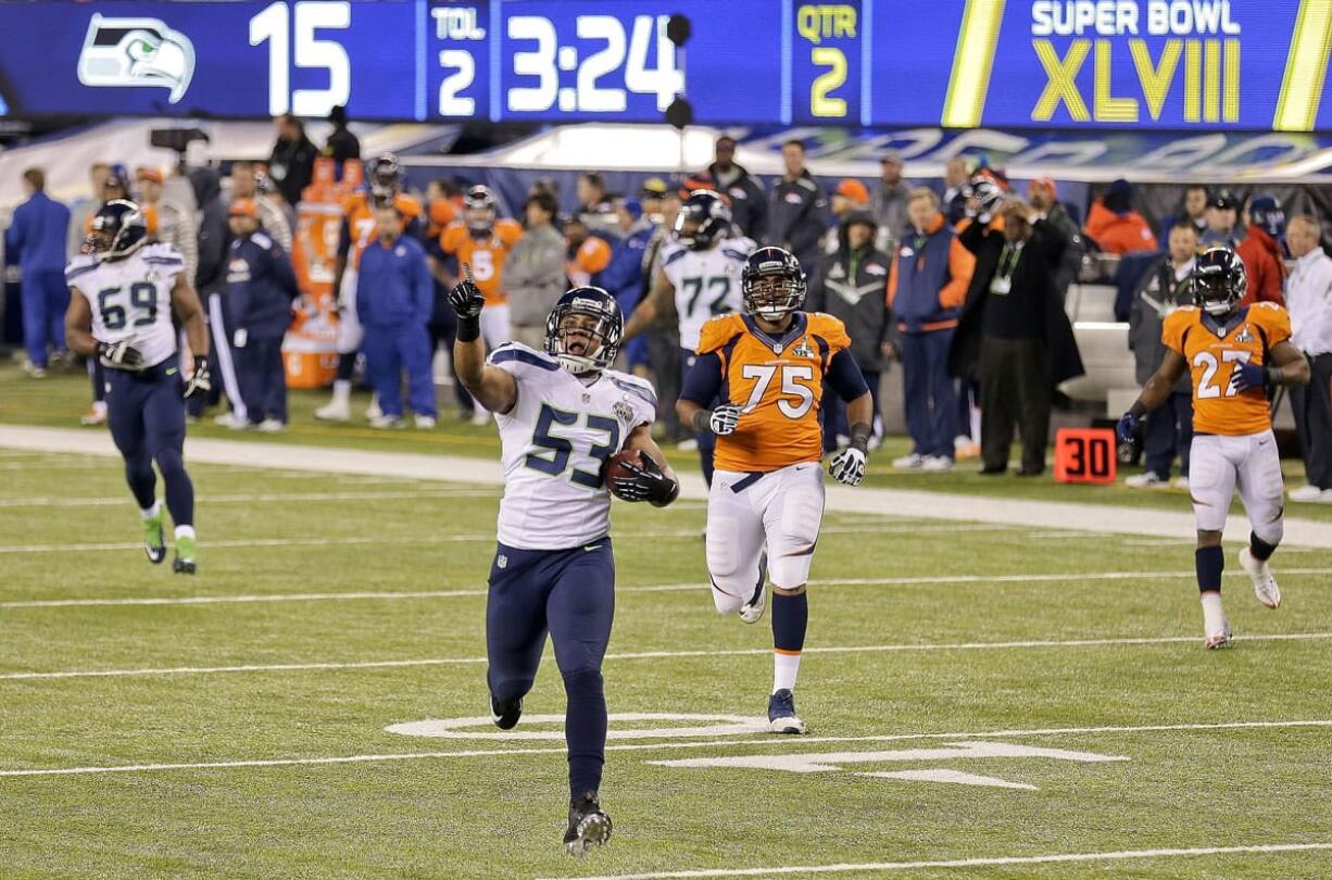 Seattle linebacker Malcolm Smith (53) returns an interception for a touchdown against Denver in Super Bowl XLVIII.