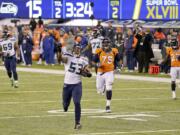 Seattle linebacker Malcolm Smith (53) returns an interception for a touchdown against Denver in Super Bowl XLVIII.