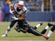 New England Patriots' Rob Gronkowski (87) is tackled by Seattle Seahawks' Kam Chancellor during a game played on Oct. 14, 2012.