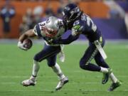 Seattle Seahawks cornerback Richard Sherman (25) tackles New England Patriots running back Shane Vereen (34) during the second half of Super Bowl XLIX on Sunday, Feb. 1, 2015, in Glendale, Ariz.