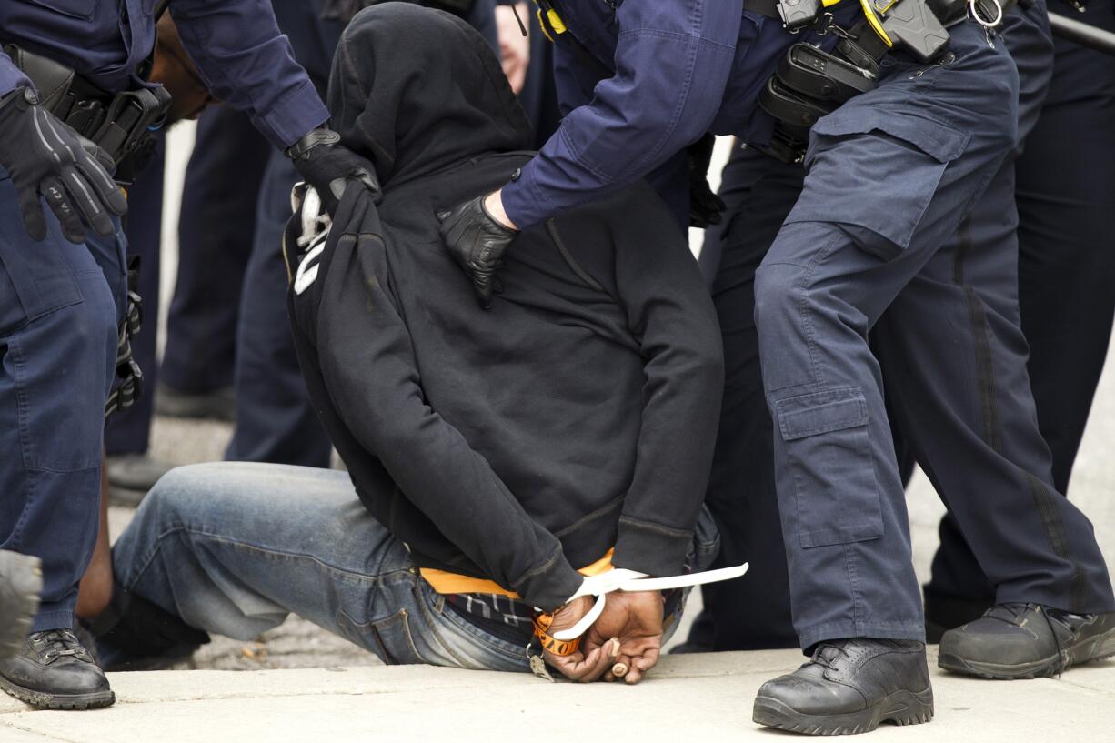 Baltimore police officers detain a demonstrator after clashes with police, after the funeral of Freddie Gray, on Monday, at New Shiloh Baptist Church in Baltimore.