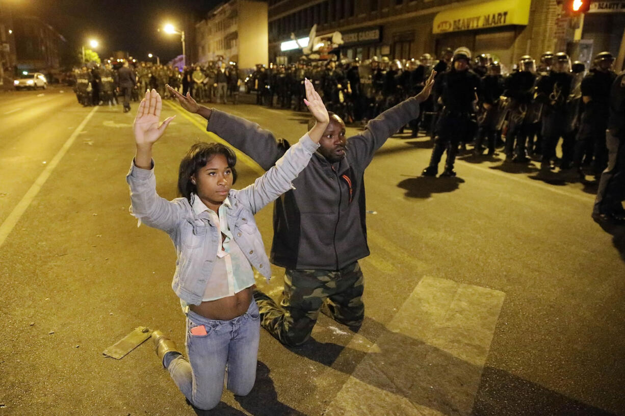 Protesters demonstrate ahead of a 10 p.m. curfew Wednesday in Baltimore.