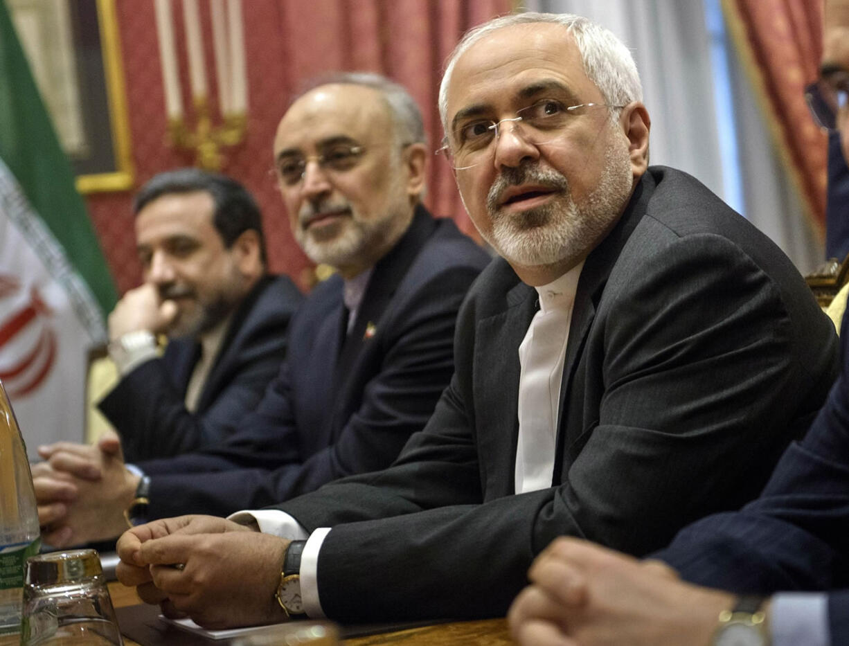 Iranian Foreign Mohammad Minister Javad Zarif , right, waits for the start of a meeting with a US delegation at a hotel in Lausanne Switzerland  on Thursday March 26, 2015 during negotiations on the Iranian nuclear programme.