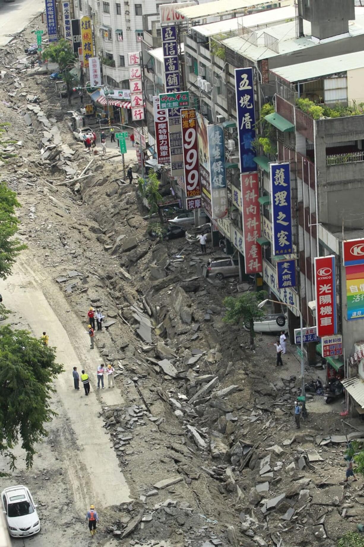 A rooftop view shows a destroyed street from an massive gas explosion in Kaohsiung, Taiwan, Friday, Aug. 1, 2014. A series of powerful gas explosions ripped through a port city in southern Taiwan midnight Thursday, killing scores of people and injuring more than 200 others, Taiwan's National Fire Agency said Friday.