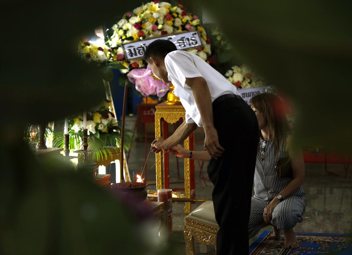 Friends and family pay respect for Waraporn Changtam at her funeral in Nonthaburi, Thailand, on Wednesday.