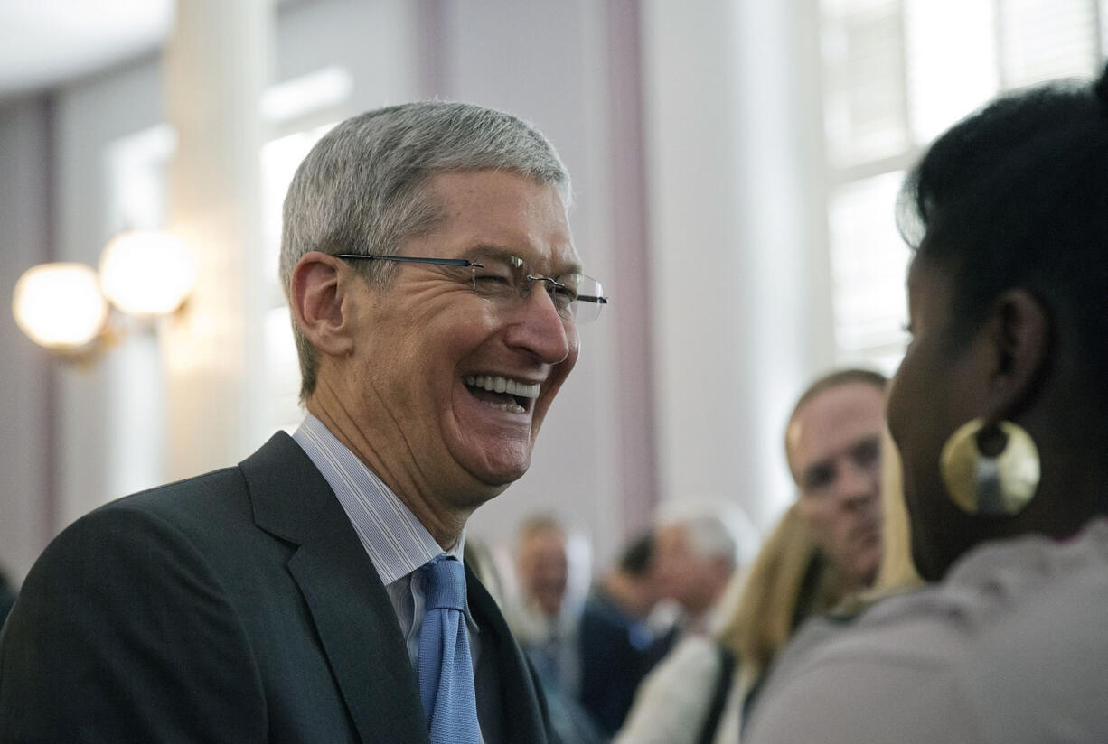 Apple chief executive and Alabama native Tim Cook laughs with a group before an Alabama Academy of Honor ceremony at the state capitol on Oct. 27in Montgomery, Ala.