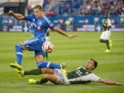 Portland Timbers' Jack Jewsbury, right, slides into Montreal Impact's Krzysztof Krol during first half at Montreal on Sunday, July 27, 2014.