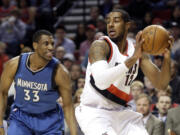 Portland Trail Blazers forward LaMarcus Aldridge looks for an opening as Minnesota Timberwolves forward Thadeus Young, left, defends during the first half Sunday, Nov. 30, 2014.