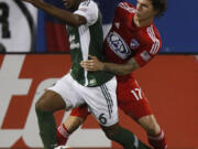 FC Dallas defender Zach Loyd (17) tries to get around the Portland Timbers forward Darlington Nagbe (6) during the first half of their match at Toyota Stadium in Frisco, Texas on Saturday, Oct. 25, 2014. (AP Photo/The Dallas Morning News, Stewart F.