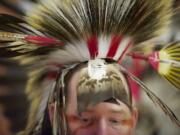 Elaborate headdresses are part of the regalia worn by dancers at the Native American Indian Education Program Title VII Traditional Pow-Wow at Covington Middle School, Saturday, March 2, 2013.