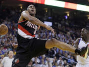 Portland Trail Blazers' Arron Afflalo, left, has his shot blocked by Golden State Warriors' Draymond Green during the first half Thursday, April 9, 2015, in Oakland, Calif.