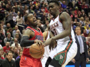 Portland Trail Blazers guard Wesley Matthews, left, is fouled by Milwaukee Bucks forward Johnny O'Bryant III, right, during the first half Saturday, Jan. 31, 2015, in Milwaukee.