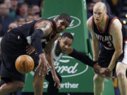 Boston Celtics' Jared Sullinger, center, battles Portland Trail Blazers' LaMarcus Aldridge, left, and Chris Kaman for a loose ball in the third quarter on Nov. 23.