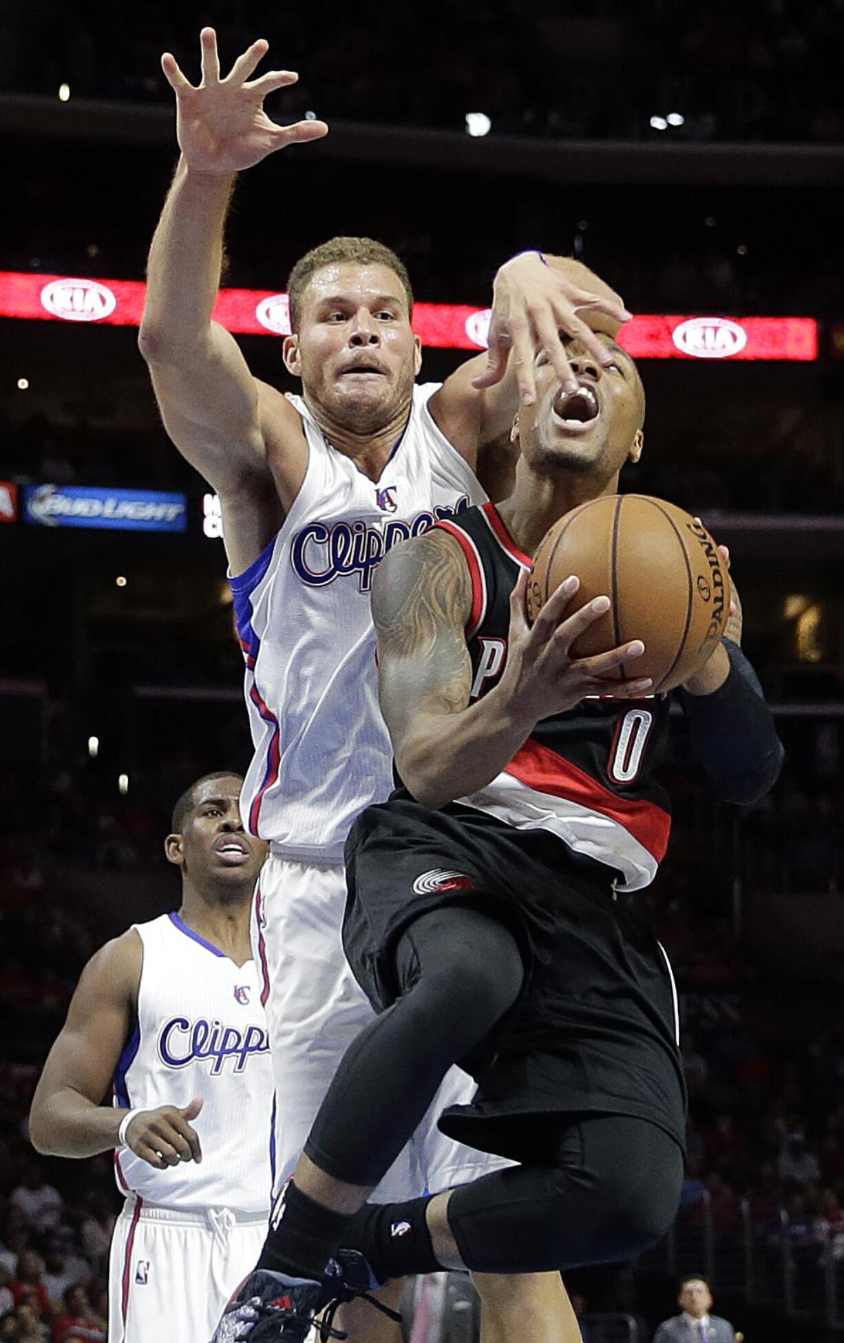 Portland Trail Blazers' Damian Lillard, right, is fouled by Los Angeles Clippers' Blake Griffin during the second half of an NBA basketball game Saturday, Nov. 8, 2014, in Los Angeles. The Clippers won 106-102. (AP Photo/Jae C.