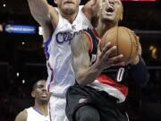 Portland Trail Blazers' Damian Lillard, right, is fouled by Los Angeles Clippers' Blake Griffin during the second half of an NBA basketball game Saturday, Nov. 8, 2014, in Los Angeles. The Clippers won 106-102. (AP Photo/Jae C.