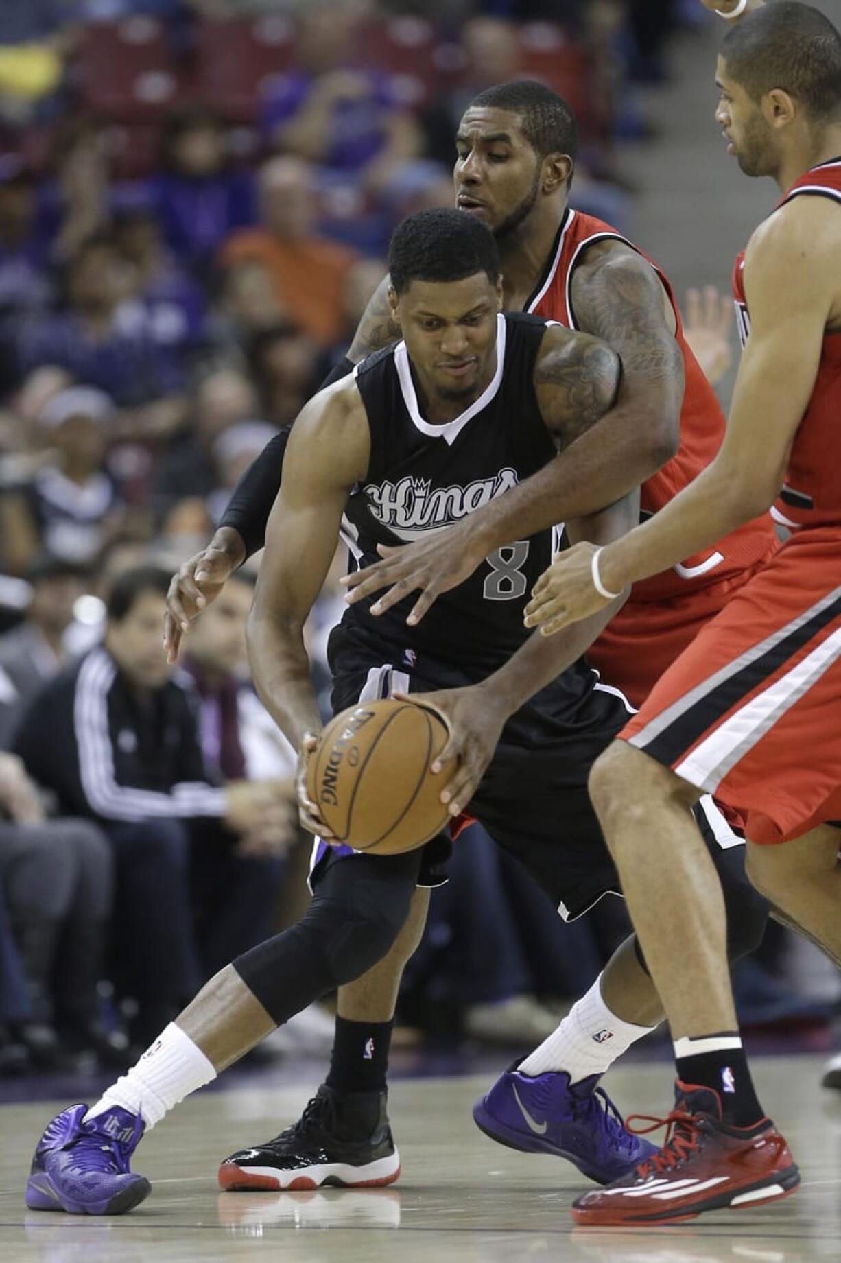 Portland's LaMarcus Aldridge, center, and Nic Batum double-team Sacramento's Rudy Gay on Friday.