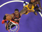 Portland Trail Blazers forward LaMarcus Aldridge, left, grabs a rebound away from Los Angeles Lakers forward Tarik Black during the first half of an NBA basketball game, Friday, April 3, 2015, in Los Angeles. (AP Photo/Mark J.