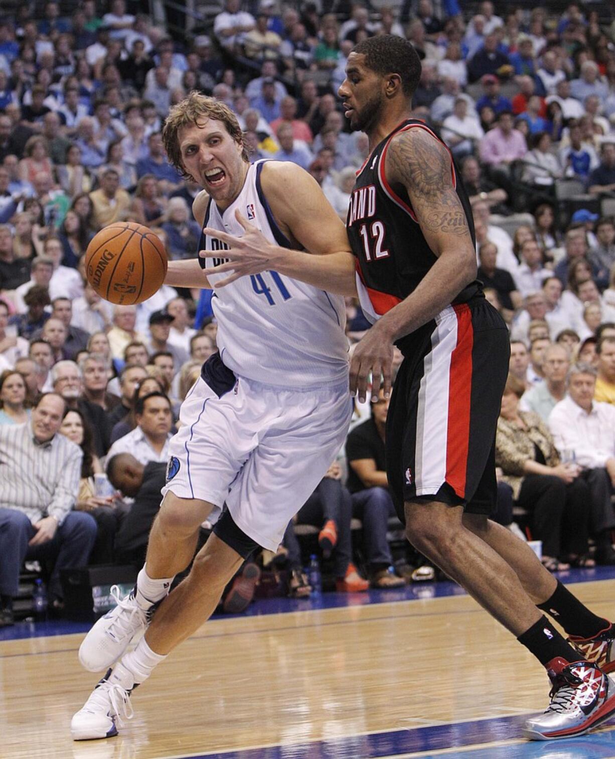 Dirk Nowitzki (41) drives past Portland's LaMarcus Aldridge (12) during the second half of Game 4.