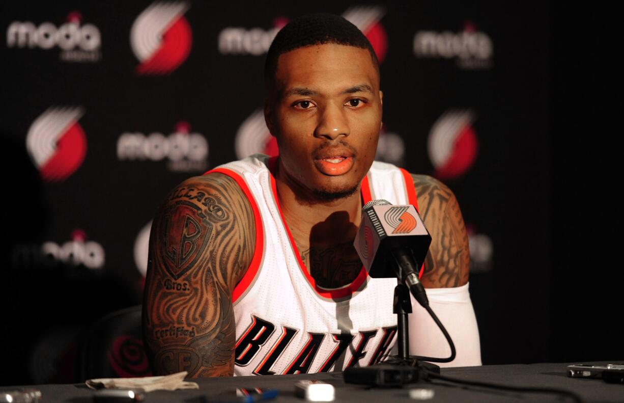 Portland Trail Blazers guard Damian Lillard (0) answers questions during media day in Portland on Monday, September 29, 2014.