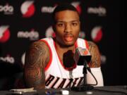 Portland Trail Blazers guard Damian Lillard (0) answers questions during media day in Portland on Monday, September 29, 2014.