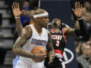 Denver Nuggets power forward Al Harrington, left, knocks Portland Trail Blazers small forward Gerald Wallace (3) off his feet while driving to the basket during the second quarter of an NBA basketball game on Wednesday, Feb. 29, 2012 in Denver.