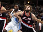 Portland Trail Blazers center Robin Lopez, right, boxes out Denver Nuggets forward Kenneth Faried, center, from a rebound.