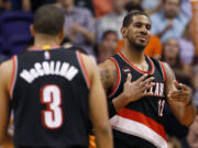 Portland Trail Blazers' LaMarcus Aldridge reacts to a basket against the Phoenix Suns' during the second half of an NBA basketball game, Friday, March 27, 2015, in Phoenix. The Trail Blazers won 87-81.