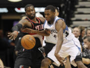 Portland Trail Blazers guard Wesley Matthews, left, strips the ball from Minnesota Timberwolves forward Andrew Wiggins during the first quarter Wednesday in Minneapolis.