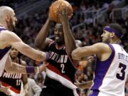 Portland's Wesley Matthews (2) drives against Phoenix Suns' Jared Dudley (3) and Marcin Gortat during the first half Friday.