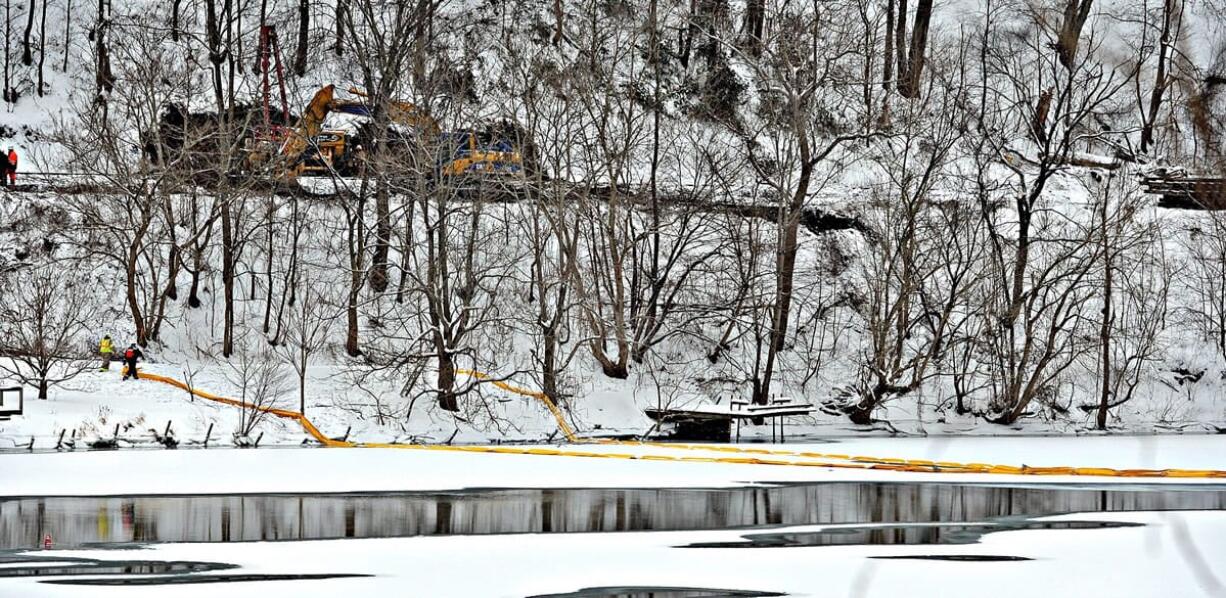 Workers clear tracks around the train derailment in Mount Carbon, W.Va., on Thursday.