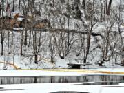 Workers clear tracks around the train derailment in Mount Carbon, W.Va., on Thursday.